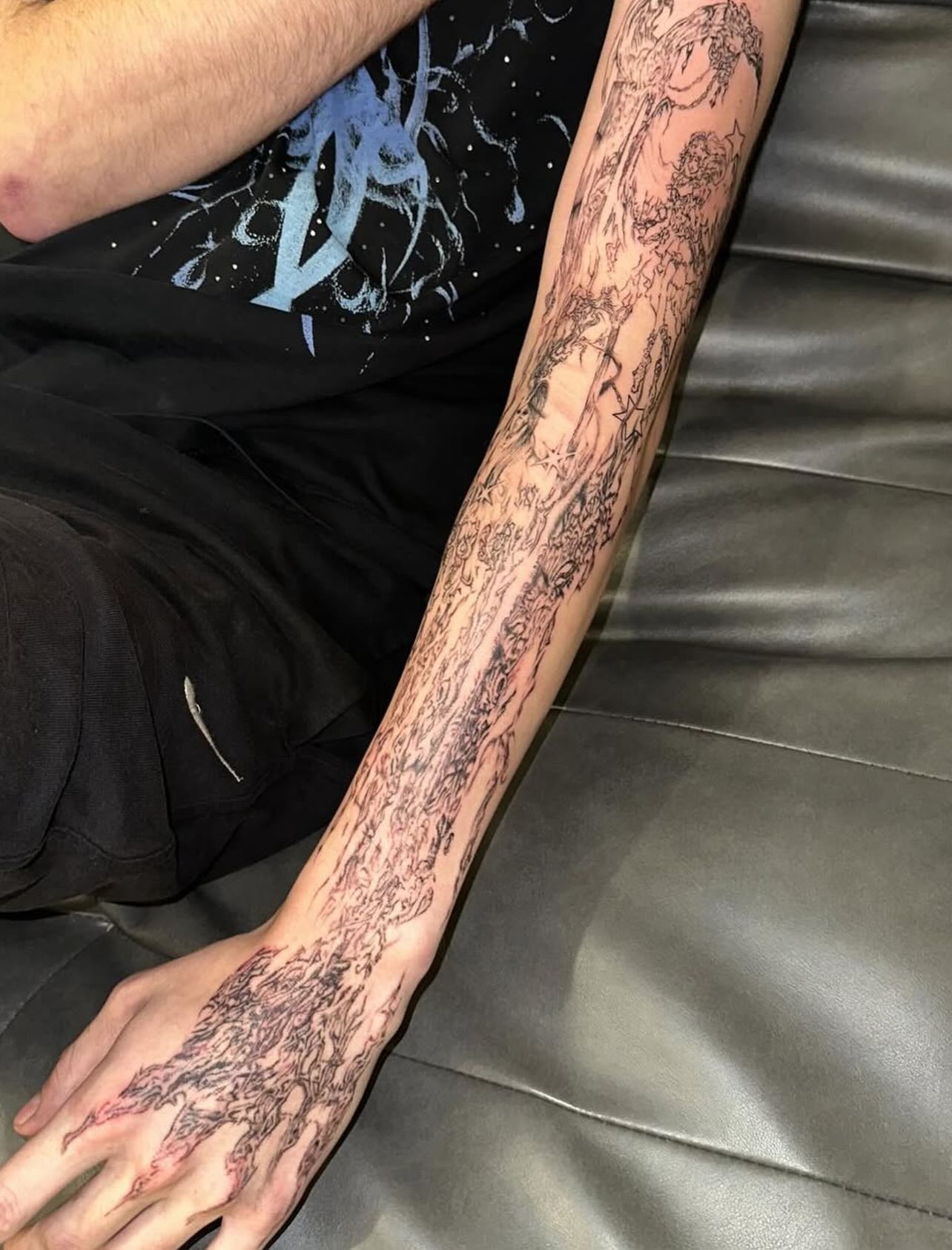 Fine-line full sleeve of ascending figures and stars